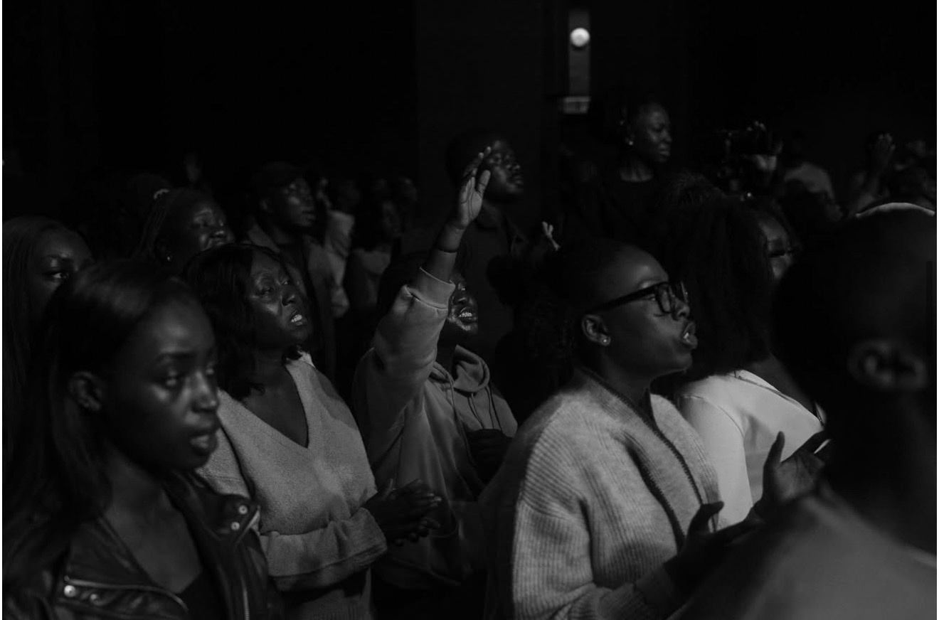 A congregation lifting their voices in worship